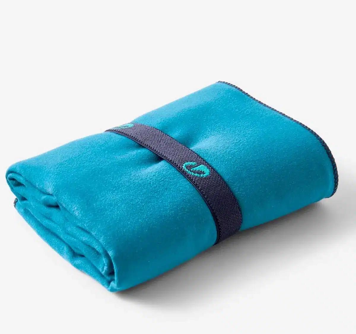 Compact turquoise microfiber towel folded with elastic strap, quick-drying and ideal for multi-day hiking trips.