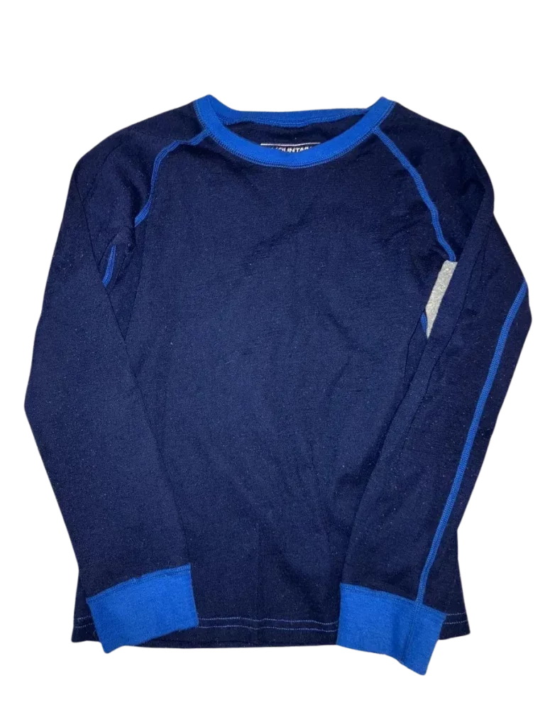 A navy blue thermal long-sleeve shirt with bright blue trim, laid flat against a plain background. A moisture-wicking thermal top like this is a key base layer for any ski trip packing list.