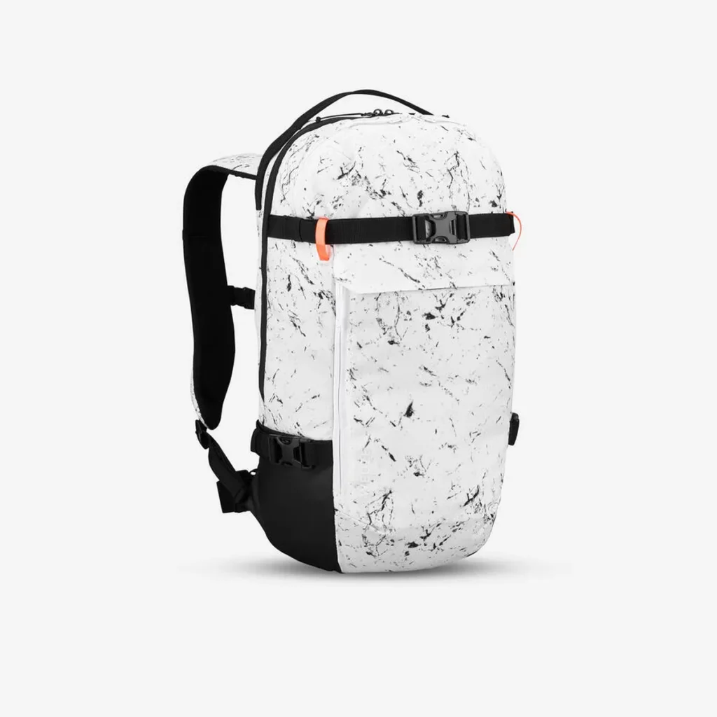 A sleek white backpack with a black splatter pattern, accented with black straps and orange clips, designed for backcountry skiing or snowboarding. A practical and stylish option among ski gifts for gear organization.