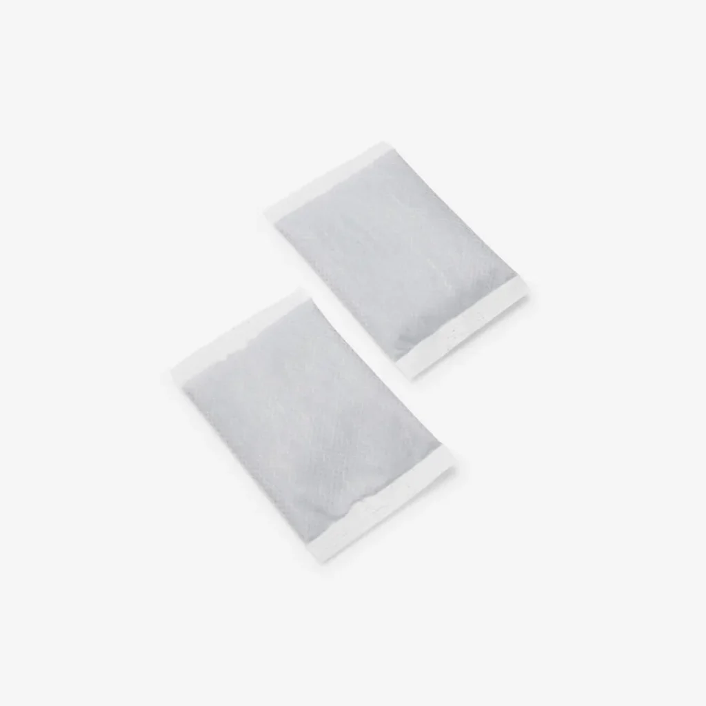 A pair of rectangular disposable hand warmers in sealed white pouches. Compact and essential, these make perfect stocking stuffers or small ski gifts for cold-weather comfort.