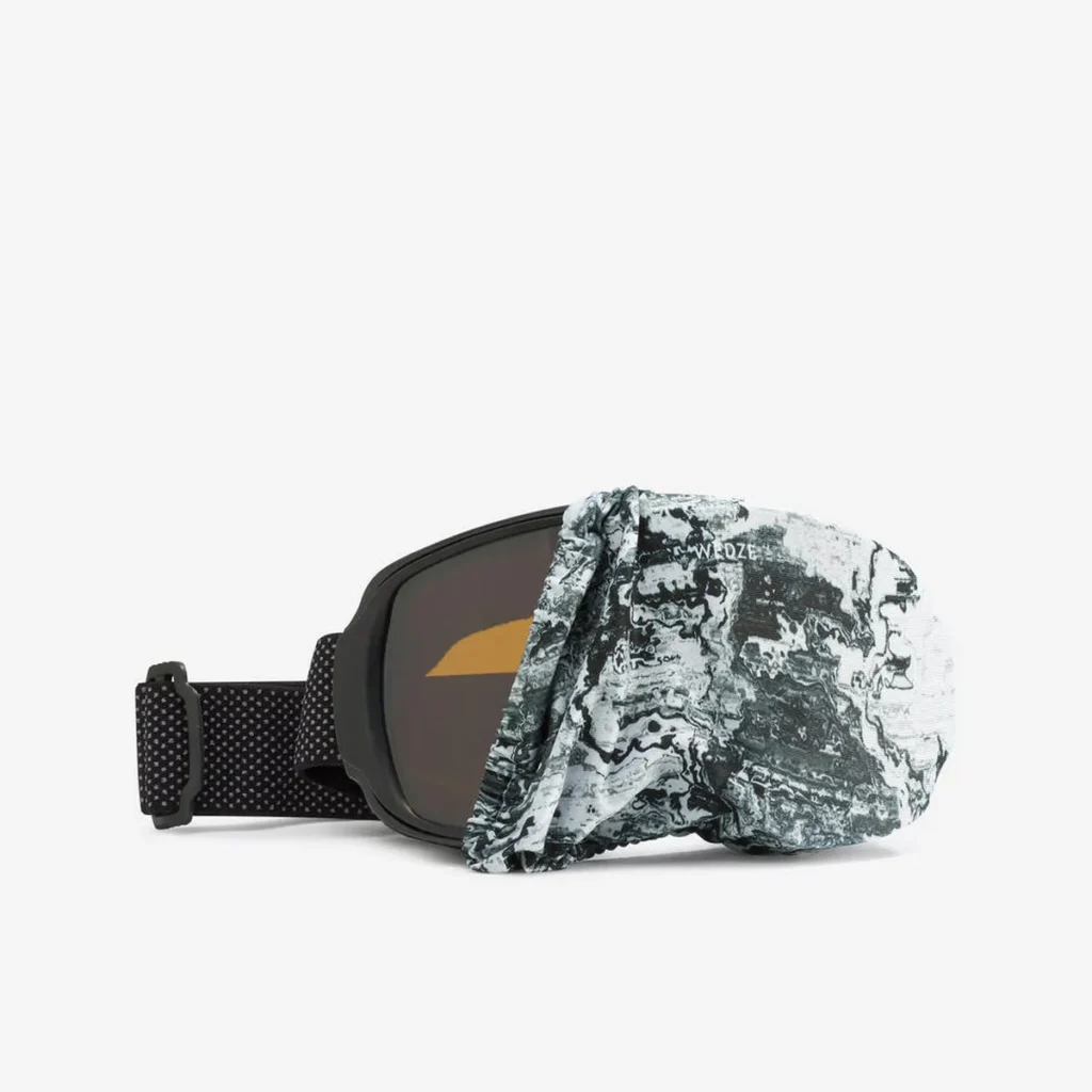 Black-lensed ski goggles with a black and white mountain map-patterned microfiber cover partially pulled over the lens. A protective and practical ski gift for any snow sports enthusiast.